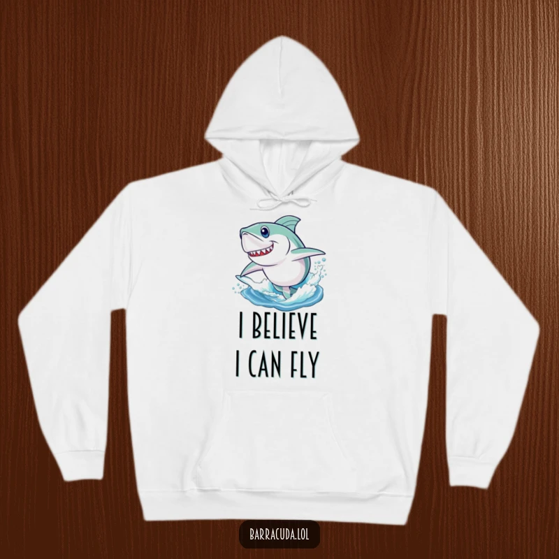 Funny hoodie showcasing a barracuda with a determined look, playfully launching itself out of the water in a dynamic jump.