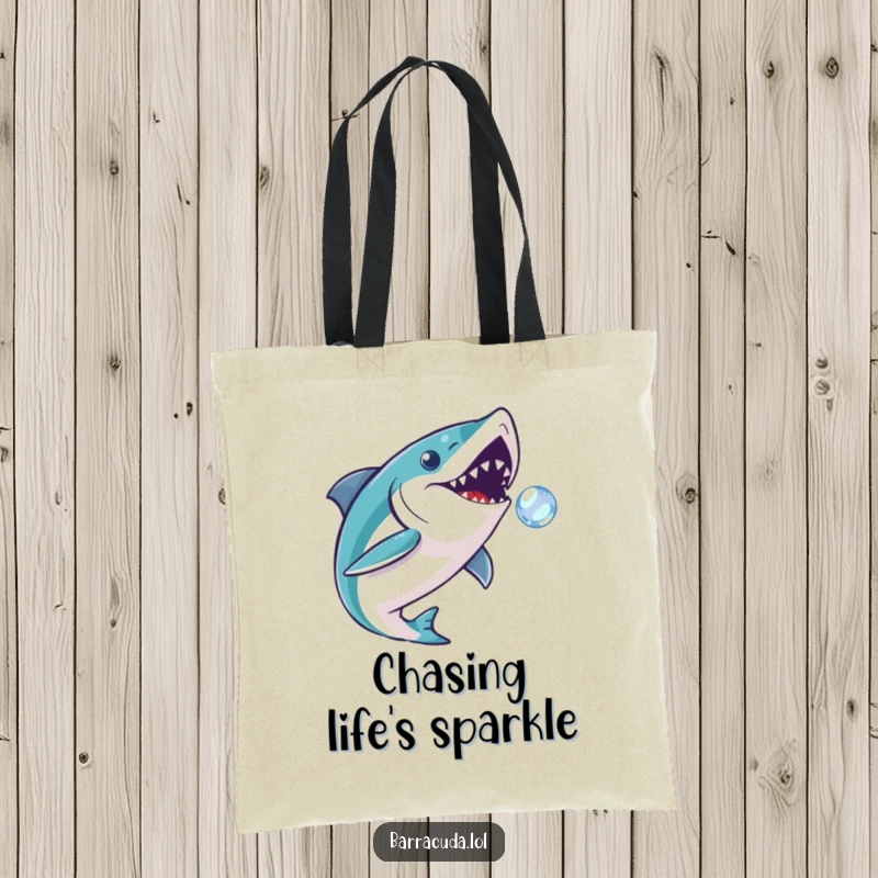 Funny barracuda tote bag of a fish playfully chasing a sparkling bubble, ideal for carrying goods with aquatic humor.