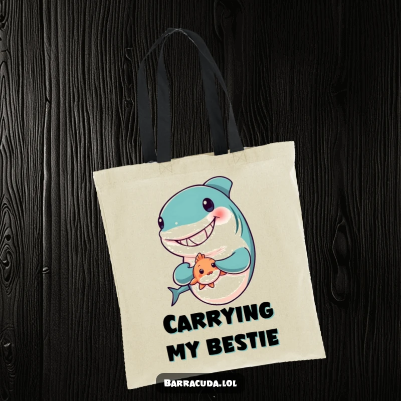 Funny tote bag showing a big-grinned barracuda holding a tiny, bashful fish, a symbol of sweet, unlikely friendship.